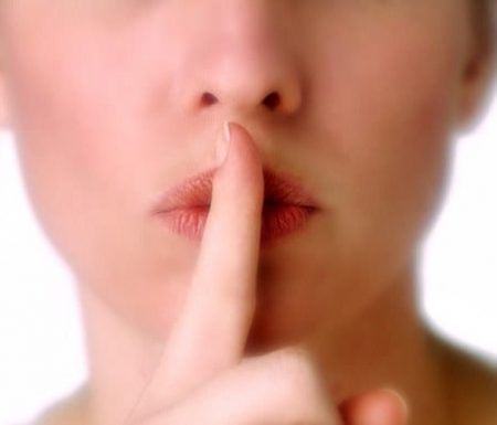 Women holding finger over mouth to shhh people