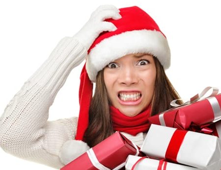 Women holding Christmas gifts looking stressed out