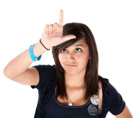 Women putting the loser sign on her head