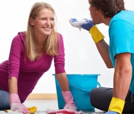Couple having fun cleaning together