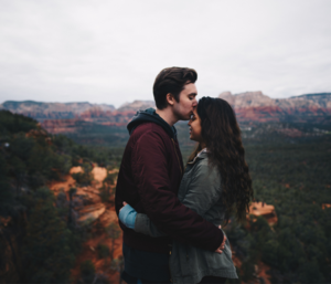 Man kissing women's forehead
