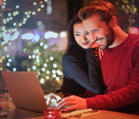 Couple looking at a computer during the Christmas season