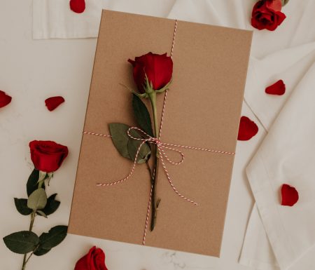Gift box with a rose tied to it