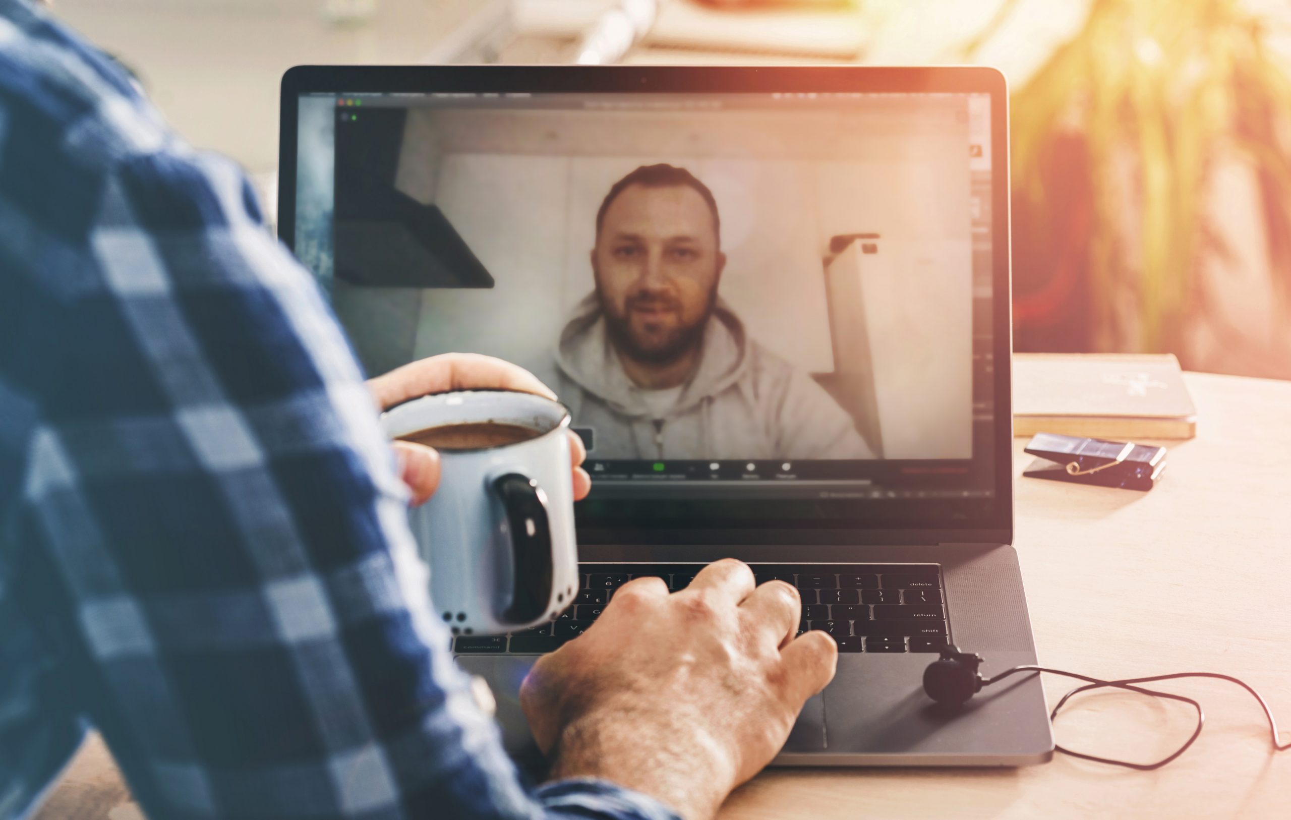 Male coach making coaching call using video call.